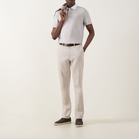 Model wearing Boggi Milano S-Caf&eacute;&reg; Piqu&eacute; Polo Shirt in sand with contrast tipping, styled with beige trousers and dark loafers.