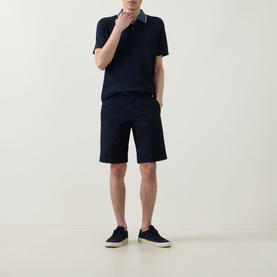 Model wearing Boggi Milano navy blue polo with contrast collar, styled with navy shorts and navy trainers.