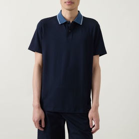 Model wearing Boggi Milano navy blue polo shirt with contrast denim-style collar and short sleeves, paired with navy trousers.