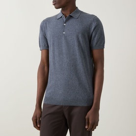 Model wearing Boggi Milano Solid Polo Shirt in indigo linen-cotton blend, with polo collar and short sleeves, styled with dark trousers.