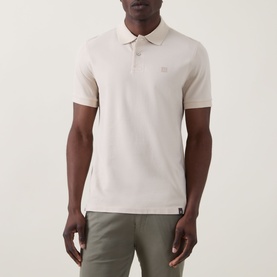 Model wearing Boggi Milano Solid Logo Piqu&eacute; Polo Shirt in Natural with piqu&eacute; texture, chest logo, styled with khaki trousers.