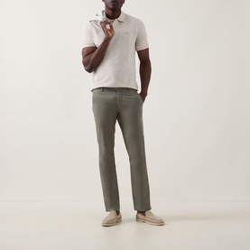 Model wearing Boggi Milano Solid Logo Piqu&eacute; Polo Shirt in Natural with olive chinos and beige loafers.