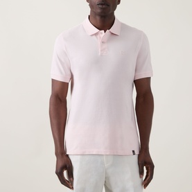 Model wearing Boggi Milano Solid Logo Piqu&eacute; Polo Shirt in pink, with two-button placket, short sleeves, and chest logo detail.