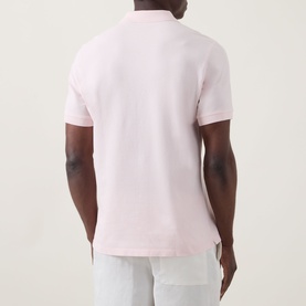 Model wearing Boggi Milano Solid Logo Piqu&eacute; Polo Shirt in pink, rear view, short sleeves, paired with light grey trousers.