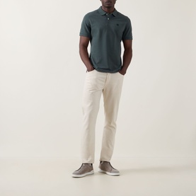 Model wearing Boggi Milano Solid Logo Piqu&eacute; Polo Shirt in green with cream chinos and grey suede trainers.