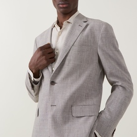 Model wearing Boggi Milano Micro Patterned Two-Piece Suit in brown, single-breasted jacket with notched lapels, styled with a light shirt.