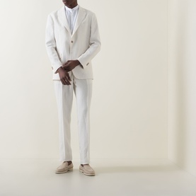 Model wearing Boggi Milano Pure Linen Single-Breasted Suit in cream, styled with a white shirt and beige espadrilles