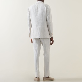 Model wearing Boggi Milano Pure Linen Single-Breasted Suit in cream, rear view showing double-vented jacket and pressed-crease trousers.