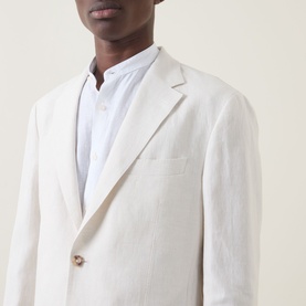 Model wearing Boggi Milano Pure Linen Single-Breasted Suit in cream, notched lapels, single button fastening, styled with white collarless shirt