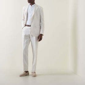 Model wearing Boggi Milano Pure Linen Single-Breasted Suit in cream, styled with a white shirt, brown belt, and taupe suede loafers.