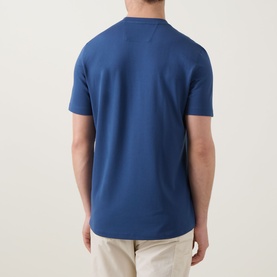 Model wearing Boggi Milano Caf&eacute; Piqu&eacute; Logo T-Shirt in Air Blue, rear view, crew neck, short sleeves, styled with beige trousers.