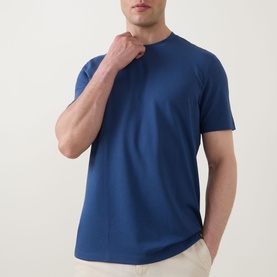 Model wearing Boggi Milano Caf&eacute; Piqu&eacute; Logo T-Shirt in Air Blue with crew neckline, short sleeves, and straight hem, styled with beige trousers.