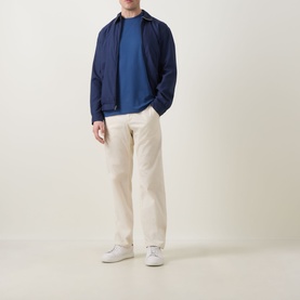 Model wearing Boggi Milano Caf&eacute; Piqu&eacute; Logo T-Shirt in Air Blue, styled with navy zip jacket, cream trousers, and white trainers.