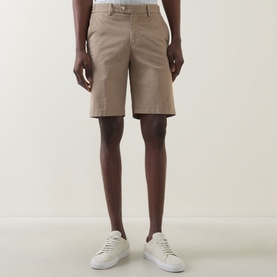 Model wearing Boggi Milano Slim-Leg Bermuda Shorts in mud, mid-rise with belt loops and concealed fly, styled with white trainers