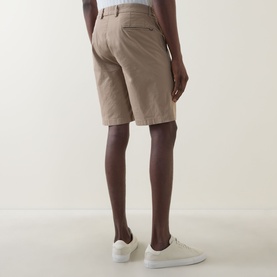 Model wearing Boggi Milano Slim-Leg Bermuda Shorts in mud, rear view showing belt loops, rear jetted pockets and clean hems, styled with white