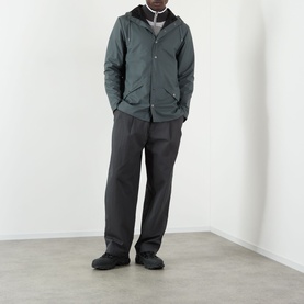 Model wearing Rains Dark Grey Casual Jacket with hood, styled with dark trousers and black shoes.