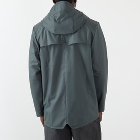 Model wearing Rains casual jacket in Dark Grey, rear view showing attached hood and curved hem split detail