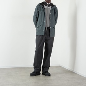 Model wearing Rains Dark Grey casual jacket with black trousers, grey cardigan and black trainers