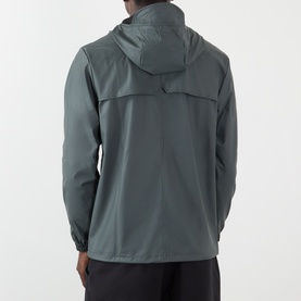 Model wearing Rains Dark Grey casual hooded jacket, rear view, lightweight polyester shell with elasticated cuffs