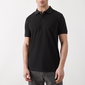 Model wearing Scotch & Soda Logo Piqu&eacute; Polo Shirt in black, short sleeves, two-button collar, tonal stitching, styled with grey jeans