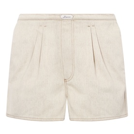 Jacquemus The De-Nimes Denim Shorts in Light Beige, mid-rise with front pleats, contrast stitching, and logo embroidery
