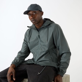 Model with Rains Water-Repellent Cap in Navy, six-panel style with curved brim, styled with a grey hooded jacket and black trousers