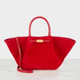 DeMellier New York Suede Midi Tote Bag in red with gold-tone hardware, tubular top handles, detachable shoulder strap, and triangular side folds