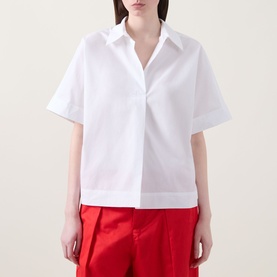 Model wearing InWear Ellin Solid Blouse in white with point collar, short sleeves and concealed fastening, styled with red wide-leg trousers.