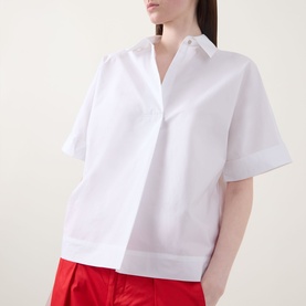 Model wearing InWear Ellin Solid Blouse in white with point collar, short sleeves and concealed front fastening, styled with red trousers.