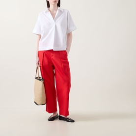 Model wearing InWear Ellin Solid Blouse in white with point collar and curved hem, styled with red wide-leg trousers and black flats.