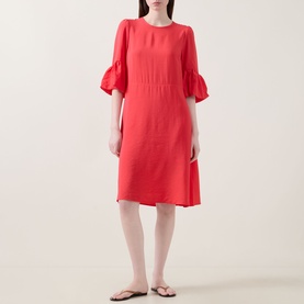 Model wearing InWear Reese Flared Dress in red with flared cuffs, round neckline, and knee-length silhouette, styled with flat sandals.