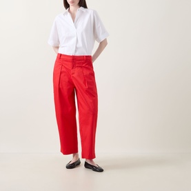 Model wearing InWear Elvia Wide-Leg Cropped Trousers in red with front pleats, styled with a white shirt and black loafers.
