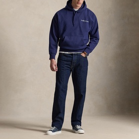 Model wearing Ralph Lauren dark cobalt hoodie with small chest logo, styled with dark indigo jeans and navy trainers.