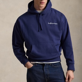 Model wearing Ralph Lauren dark cobalt pullover hoodie with front pouch pocket and drawstring hood, styled with blue jeans and white T-shirt.