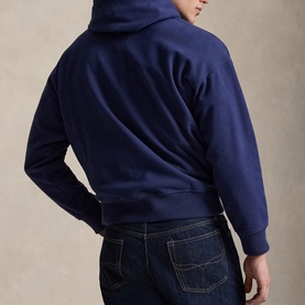 Model wearing Ralph Lauren dark cobalt hoodie, rear view, styled with dark wash jeans