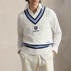 Model wearing Ralph Lauren Wimbledon Logo Cricket Knitted Sweater Vest in cream, V-neck with navy and blue stripe trim, over white shirt with cream