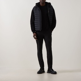 Model wearing Calvin Klein Black Crew Neck T-Shirt styled with dark puffer gilet, black trousers and leather shoes.
