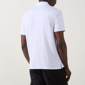 Model wearing Calvin Klein Monogram Logo Polo Shirt in Bright White, rear view, short sleeves, straight hem with split side seams.