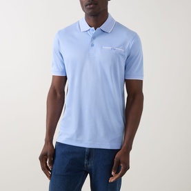 Model wearing Bugatti Contrast Tipped Polo Shirt in light blue with ribbed collar tipping and chest pocket, styled with dark blue jeans.