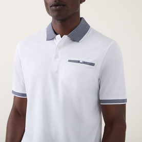 Model wearing Bugatti Contrast Collar Polo Shirt in white with grey tipped collar, matching cuffs, three-button placket and chest pocket.