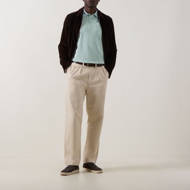 Model wearing Bugatti Mint Patch Pocket Polo Shirt with dark cardigan, beige trousers and dark loafers.