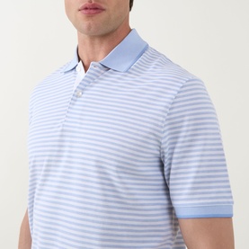Model wearing Bugatti Stripe Logo Polo Shirt in light blue and white horizontal stripes, flat collar, short sleeves, button fastening.