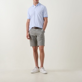 Model wearing Bugatti Classic Bermuda Shorts in light green with belt loops, styled with a light blue polo shirt and white trainers.