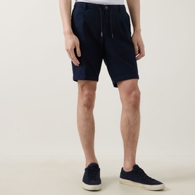 Model wearing Bugatti Lightweight Drawstring Shorts in navy linen-blend, styled with navy trainers