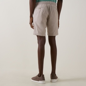 Model wearing Bugatti Lightweight Drawstring Shorts in stone, rear view showing elasticated waist and welt pockets, styled with grey slip-on shoes.