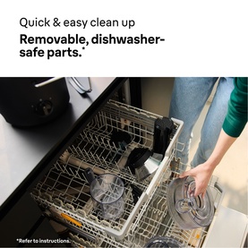 Braun MultiJuice 5 Spin Juicer Black removable parts being placed in a dishwasher, highlighting easy clean-up.