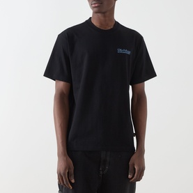 Model wearing Dickies Fairlawn Graphic T-Shirt in black with blue chest graphic, crew neck, short sleeves, styled with dark jeans