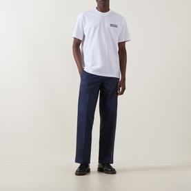 Model wearing Dickies 247 Loose Work Trousers in Navy Blue, straight-leg fit with clean hems, styled with a white T-shirt and black loafers.