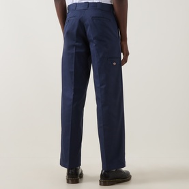 Model wearing Dickies 247 Loose Work Trousers in Navy Blue, straight-leg fit, rear welt pockets visible, paired with black loafers.