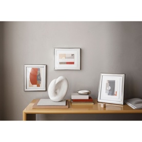 Georg Jensen Deco Picture Frame Large in mirror-polished silver stainless steel, styled on a wooden console with abstract wall art and sculptural